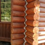 Chinking on a corner of a log home restored by Wild Wood Log Home Restoration.